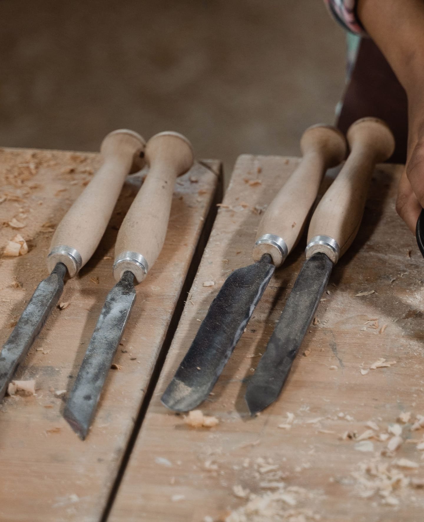 Turning chisels laid on a joiner’s bench among wood shavings