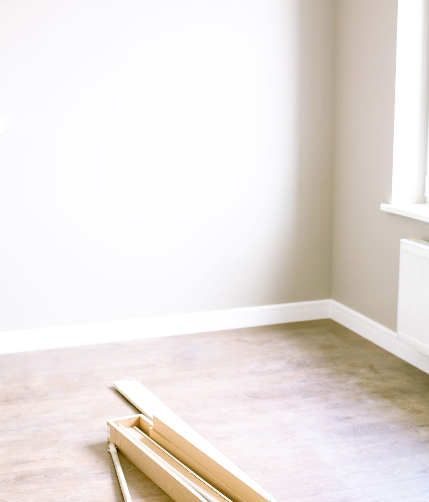 Freshly decorated empty room with new floorboards being laid